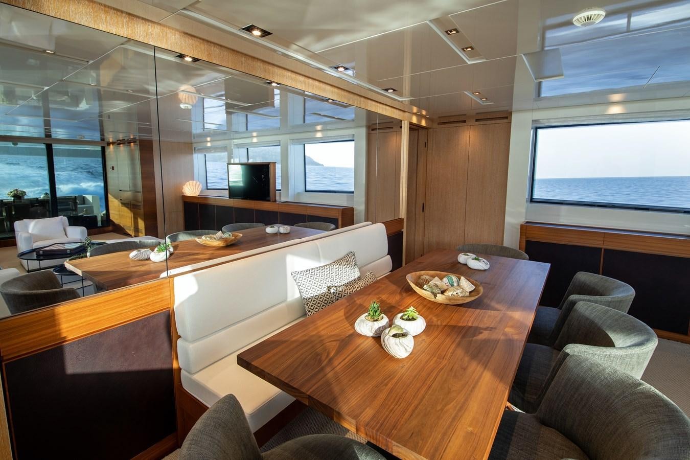 a room with a table and chairs aboard CYBELE Yacht for Sale