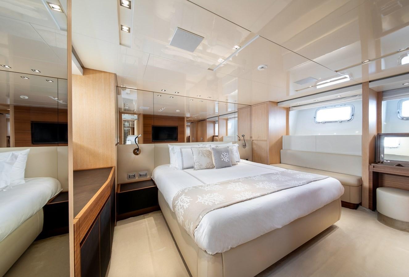 a room with a bed and a desk aboard CYBELE Yacht for Sale