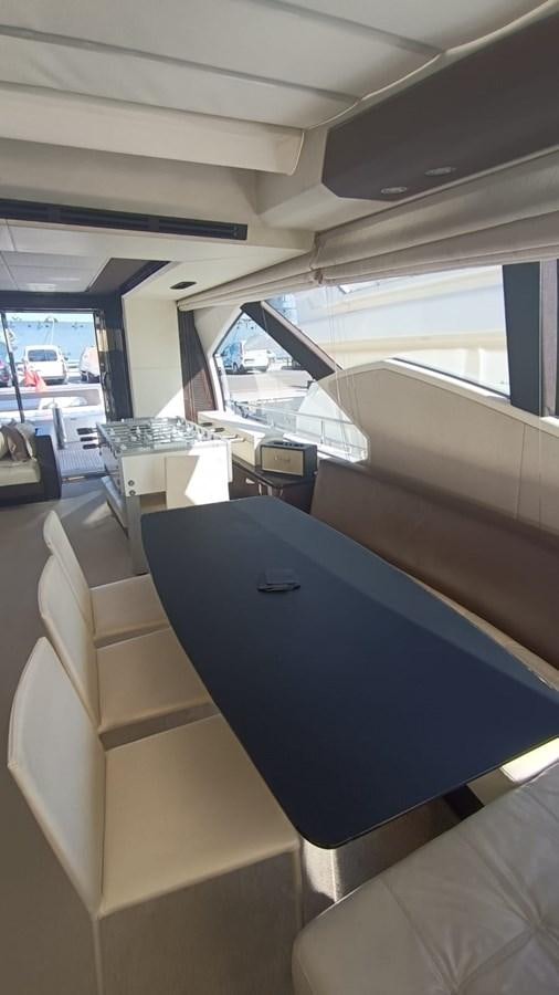 inside of a vehicle with a table and chairs and a window with a view of the street and aboard BELLA MIA Yacht for Sale