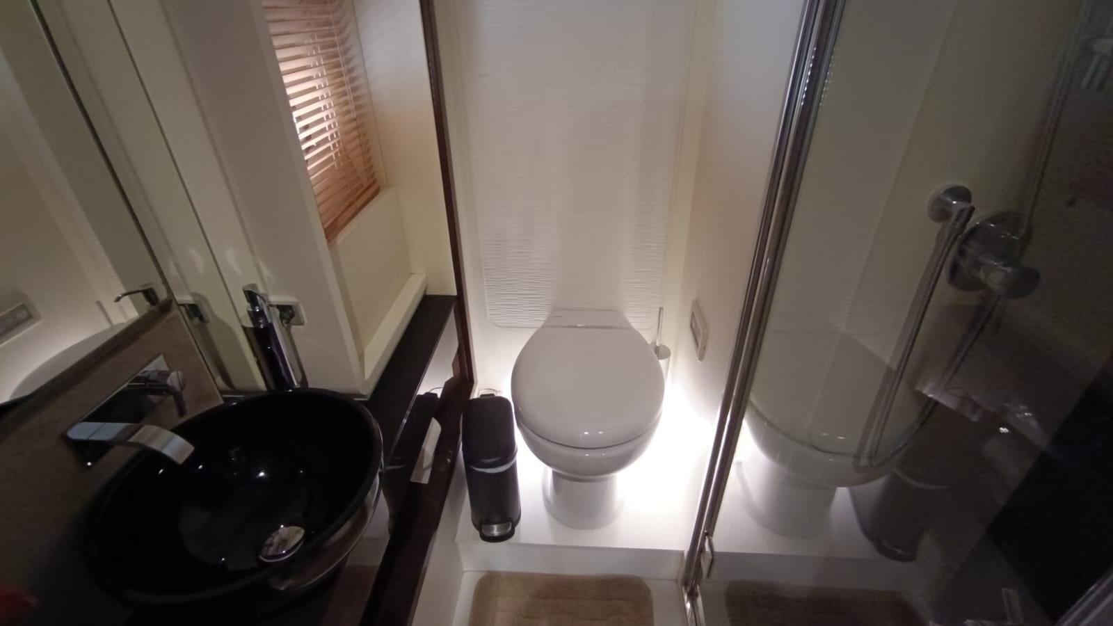 a bathroom with a toilet and a sink aboard BELLA MIA Yacht for Sale