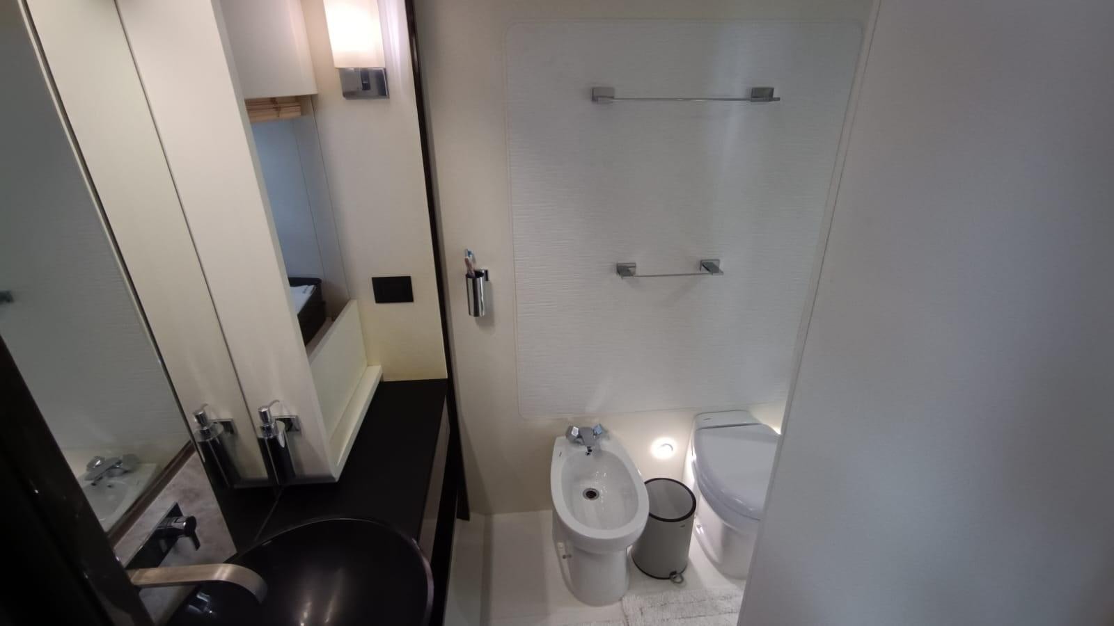 a bathroom with a toilet and a sink aboard BELLA MIA Yacht for Sale