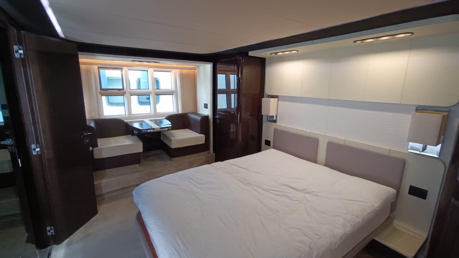a hotel room with a bed and a couch aboard BELLA MIA Yacht for Sale
