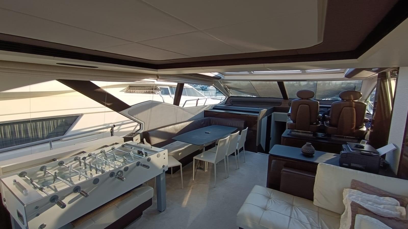 a room with a pool table and chairs aboard BELLA MIA Yacht for Sale