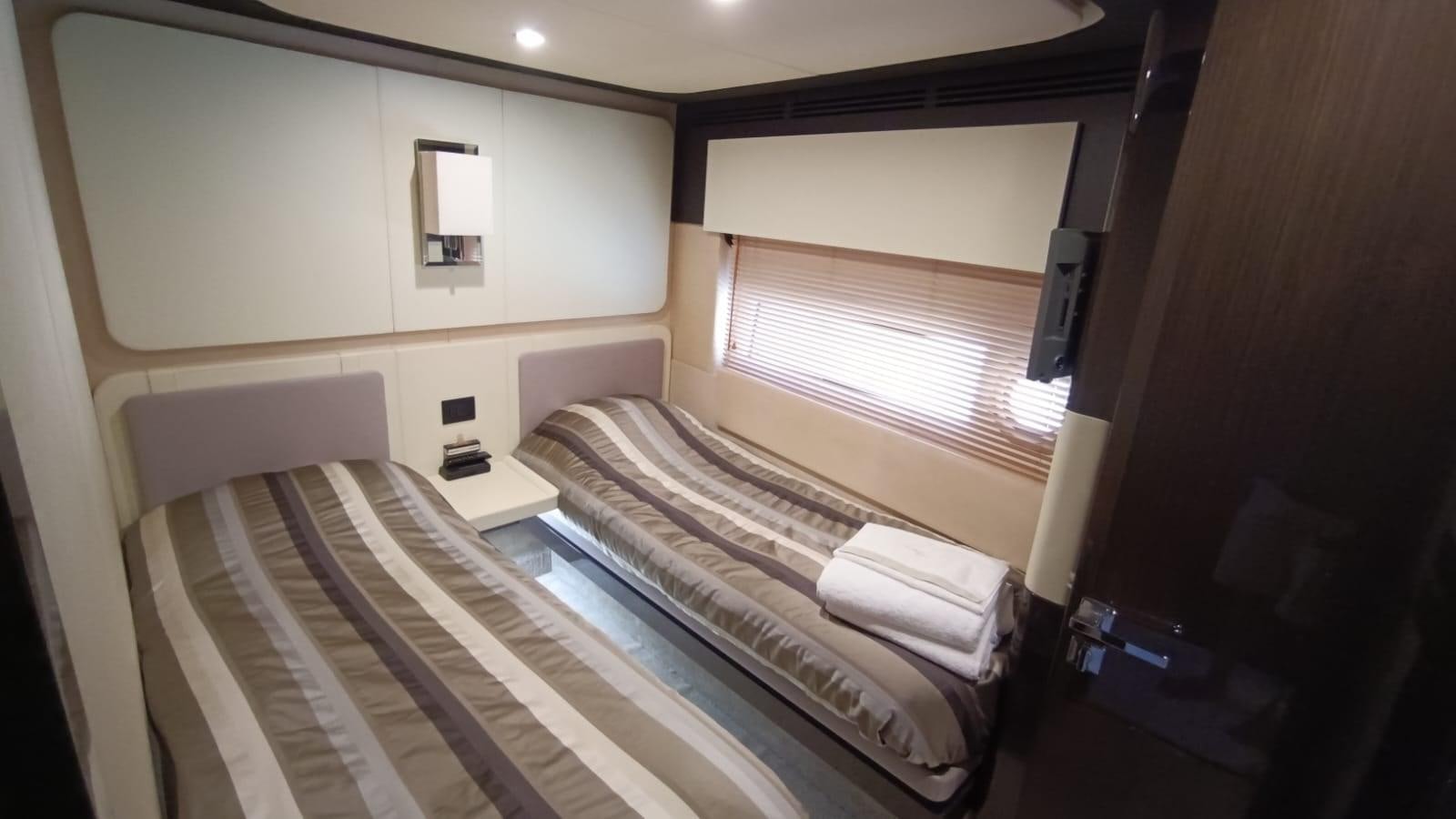 a room with a bed and a window aboard BELLA MIA Yacht for Sale