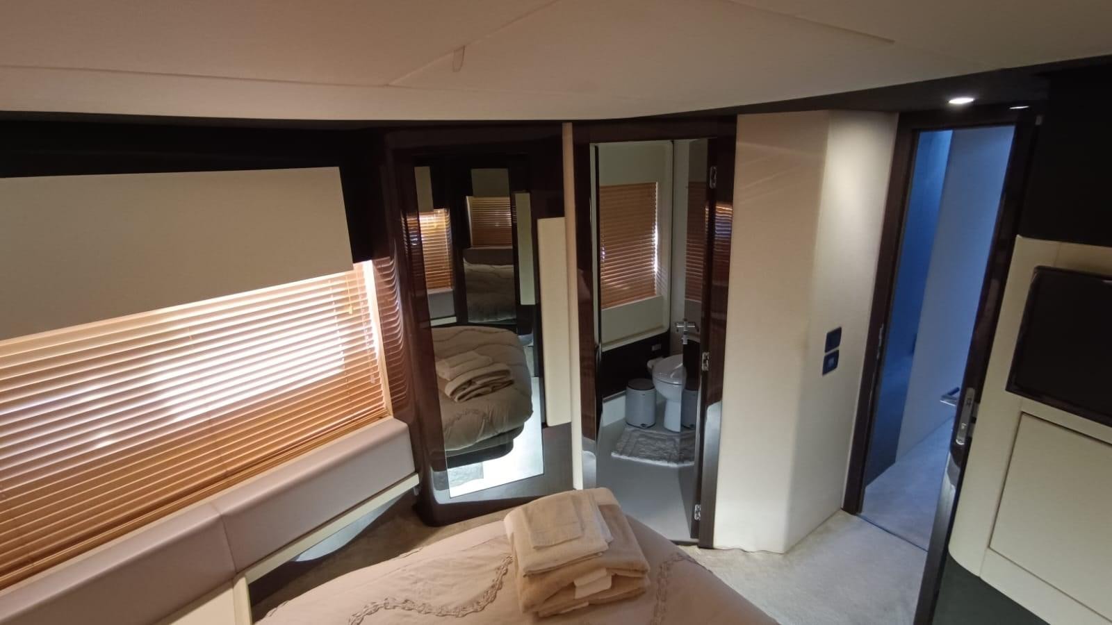 a room with a bed and a mirror aboard BELLA MIA Yacht for Sale