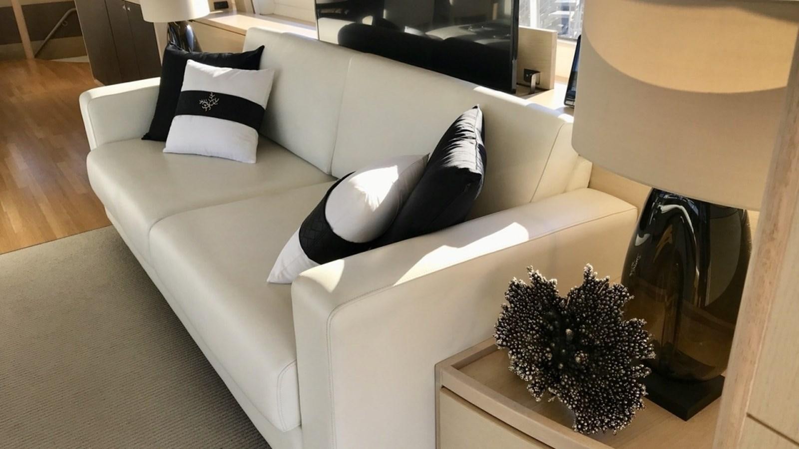 a living room with a couch and a coffee table aboard MS FELICE Yacht for Sale
