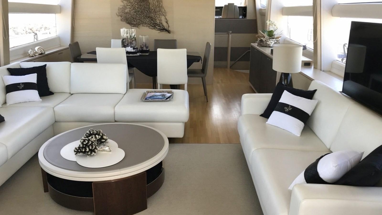 a living room with white couches aboard MS FELICE Yacht for Sale