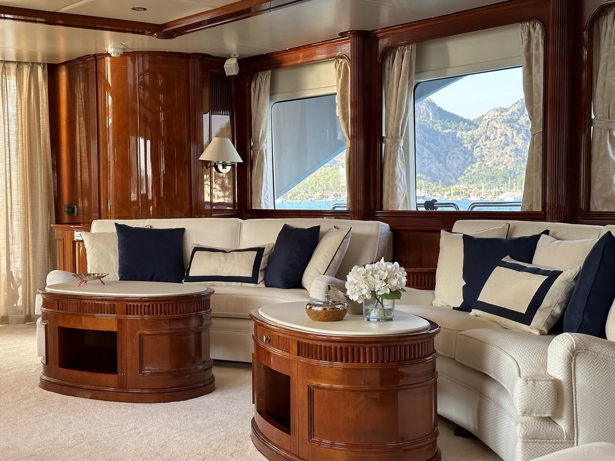 a living room with a couch and a table aboard FRIENDSHIP Yacht for Sale