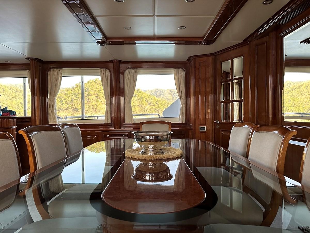 a wooden cabin with a round table aboard FRIENDSHIP Yacht for Sale