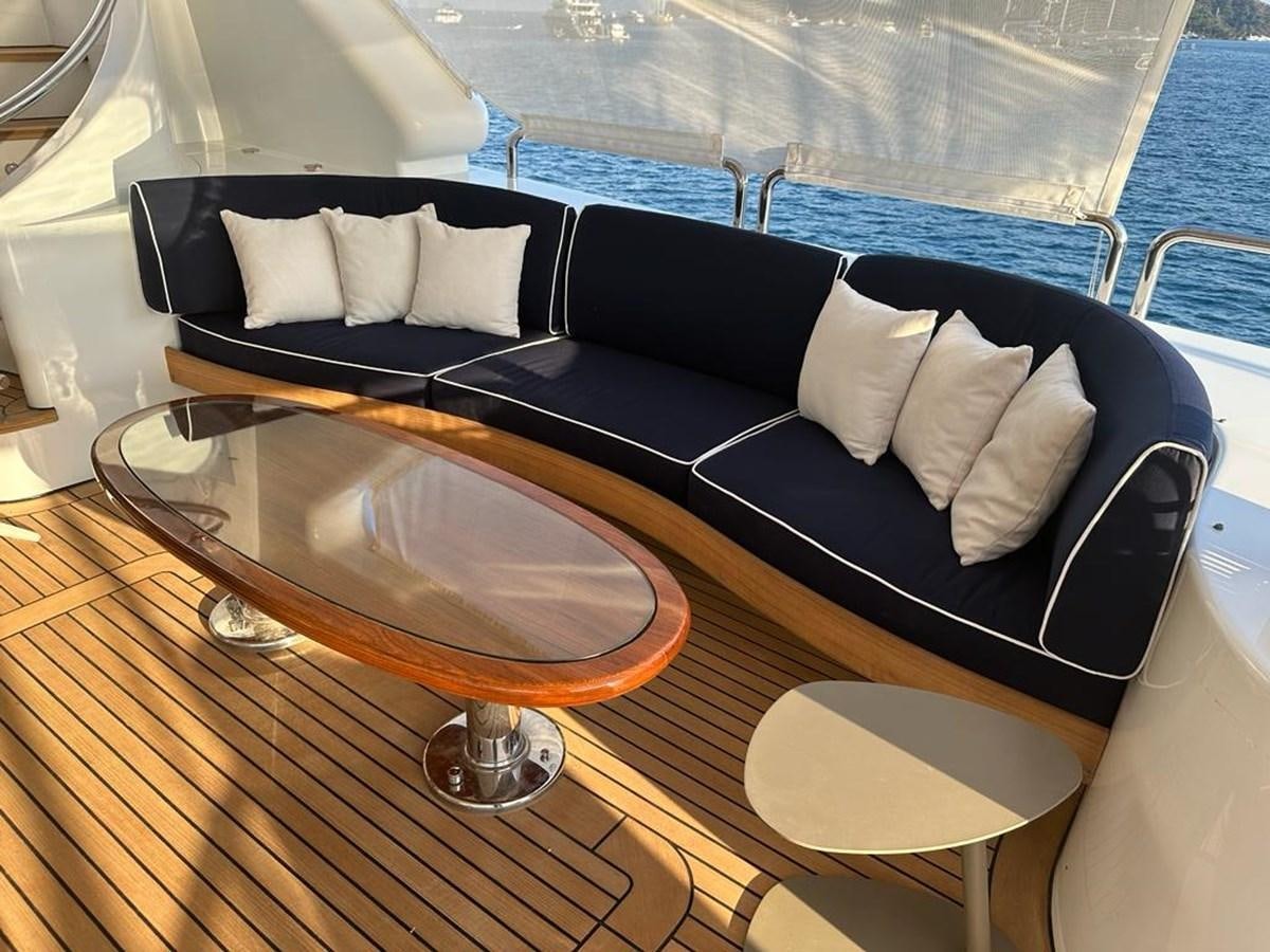 a couch with a table and chairs aboard FRIENDSHIP Yacht for Sale