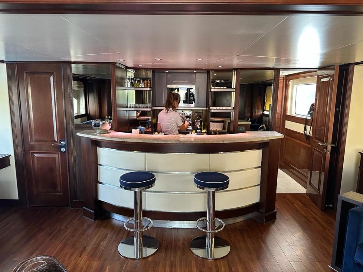 a person sitting at a counter aboard FRIENDSHIP Yacht for Sale