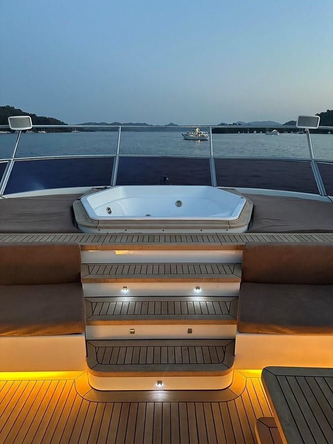 a deck with a large boat in the background aboard FRIENDSHIP Yacht for Sale