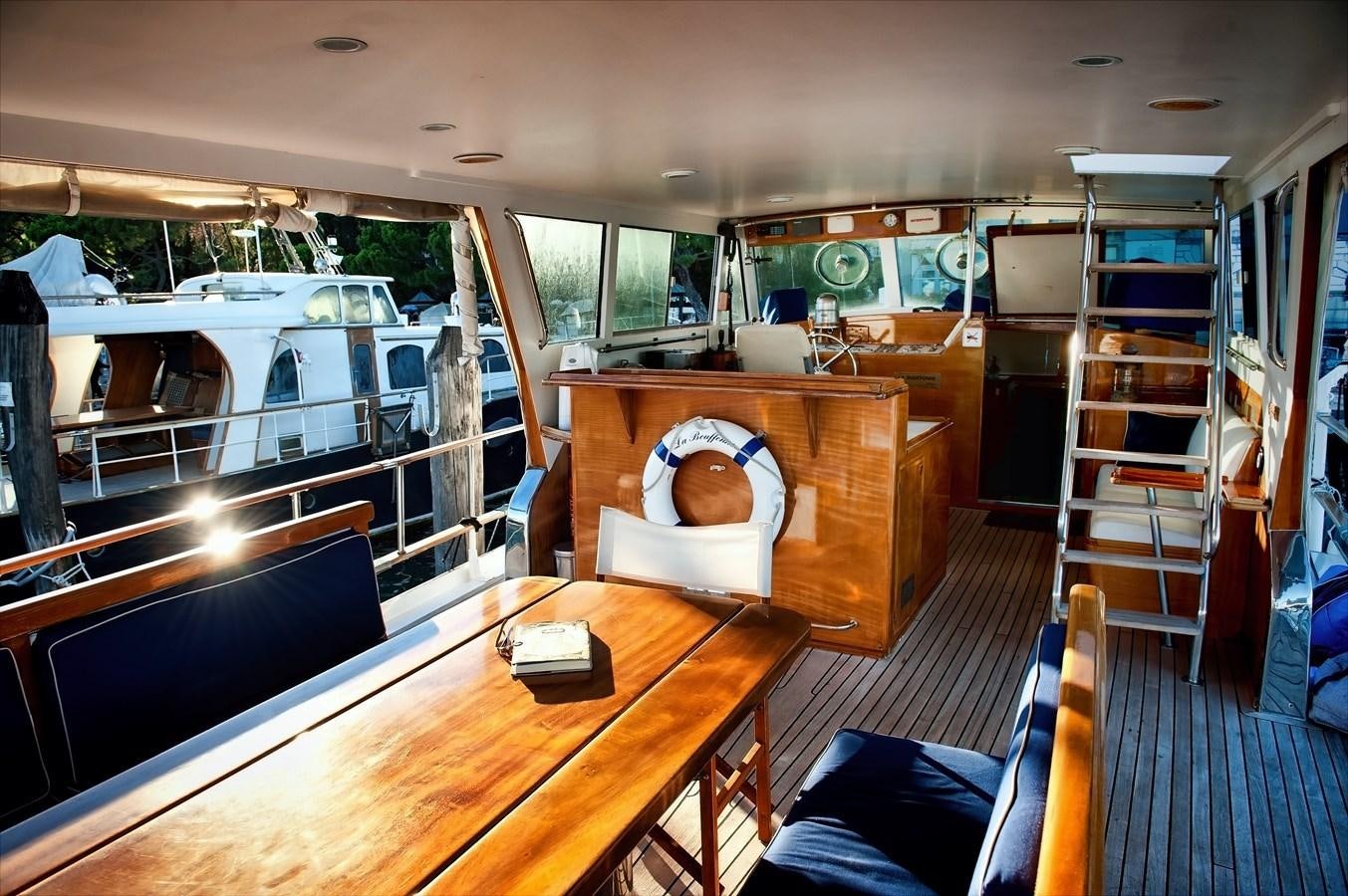 a room with a bed and a table aboard LA BOUFFONNE Yacht for Sale