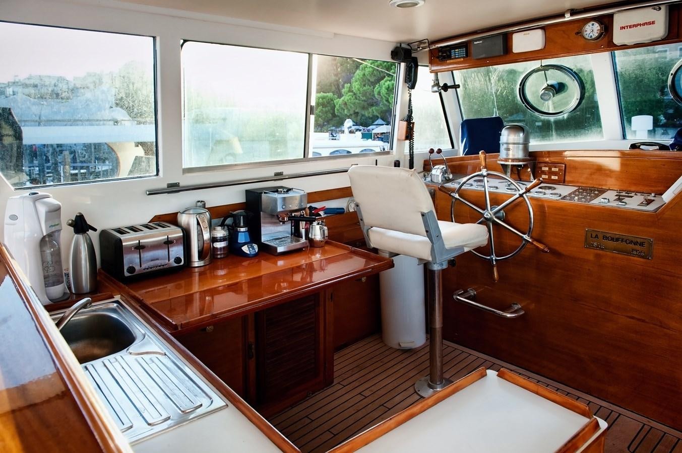 a kitchen with a sink and a stove aboard LA BOUFFONNE Yacht for Sale