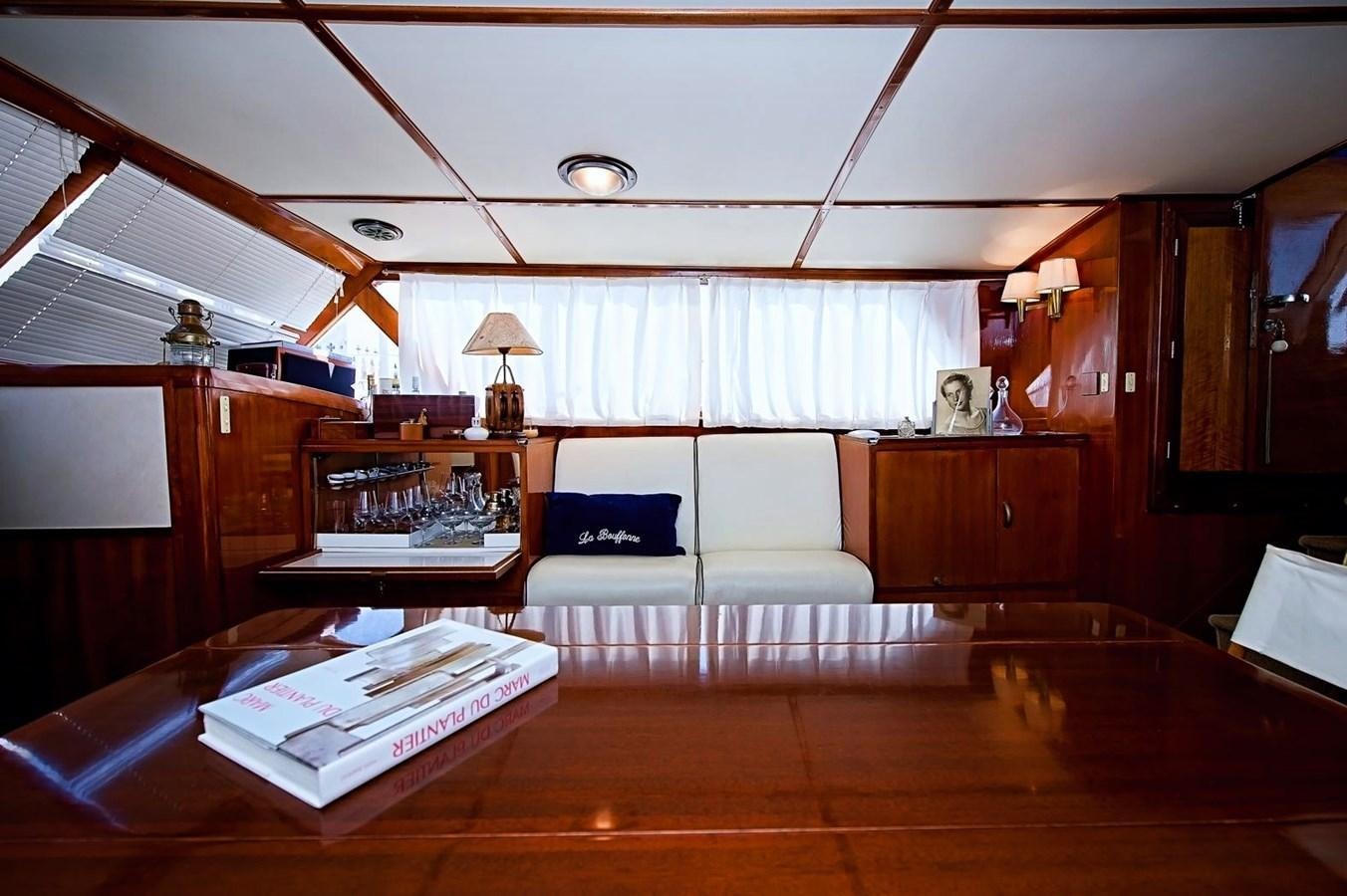 a living room with a wood floor aboard LA BOUFFONNE Yacht for Sale