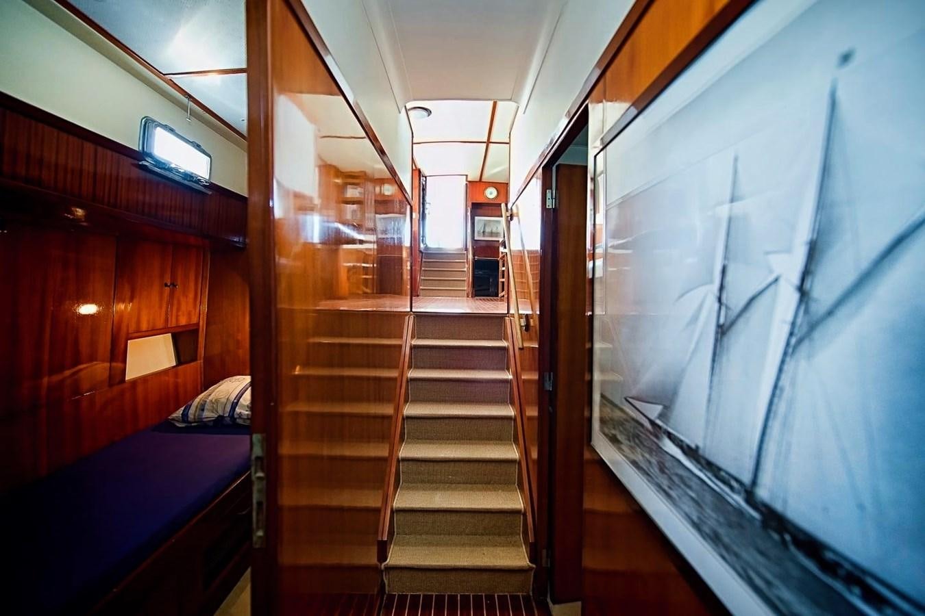 a train with a bed and a blue bed aboard LA BOUFFONNE Yacht for Sale