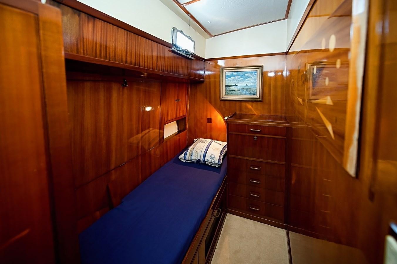 a room with a bed and a dresser aboard LA BOUFFONNE Yacht for Sale