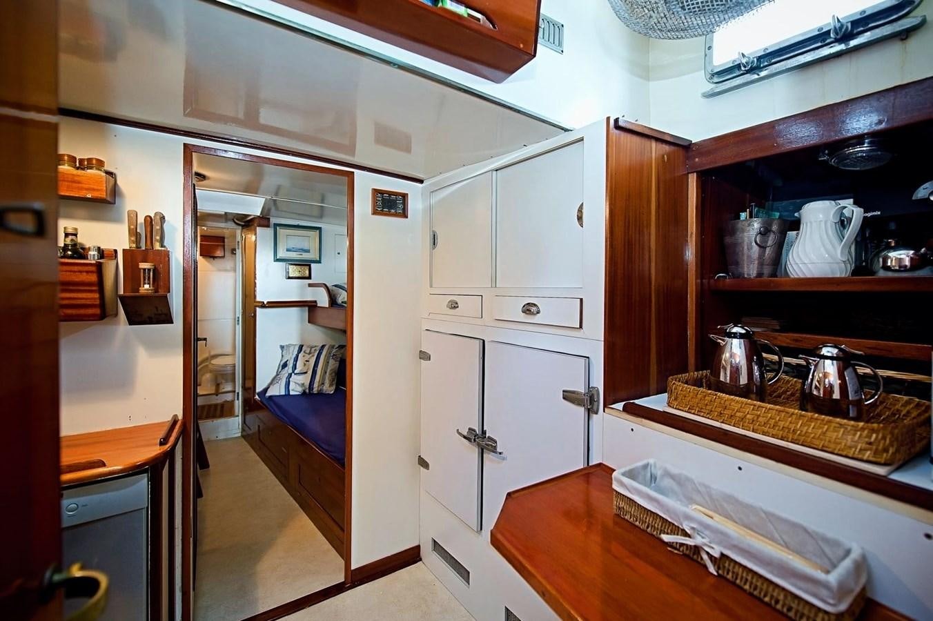 a kitchen with a sink and a bed aboard LA BOUFFONNE Yacht for Sale