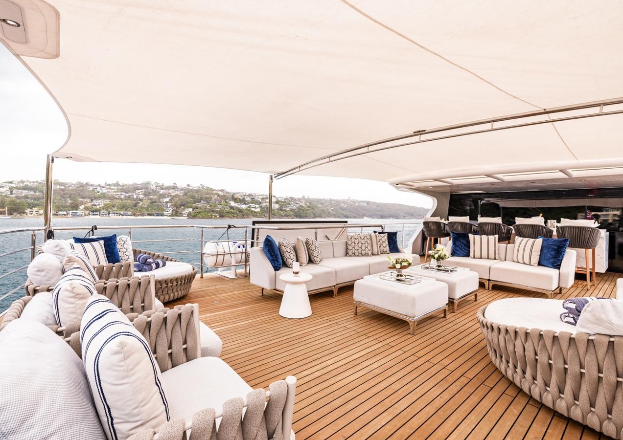 a room with a large deck and a view of the city aboard EVOLUTION 1 Yacht for Sale