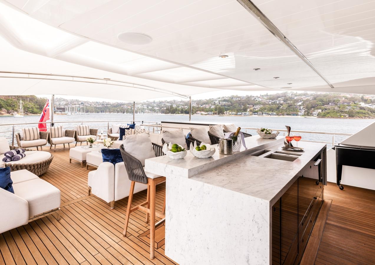 a large white table with chairs and a large window overlooking a city aboard EVOLUTION 1 Yacht for Sale