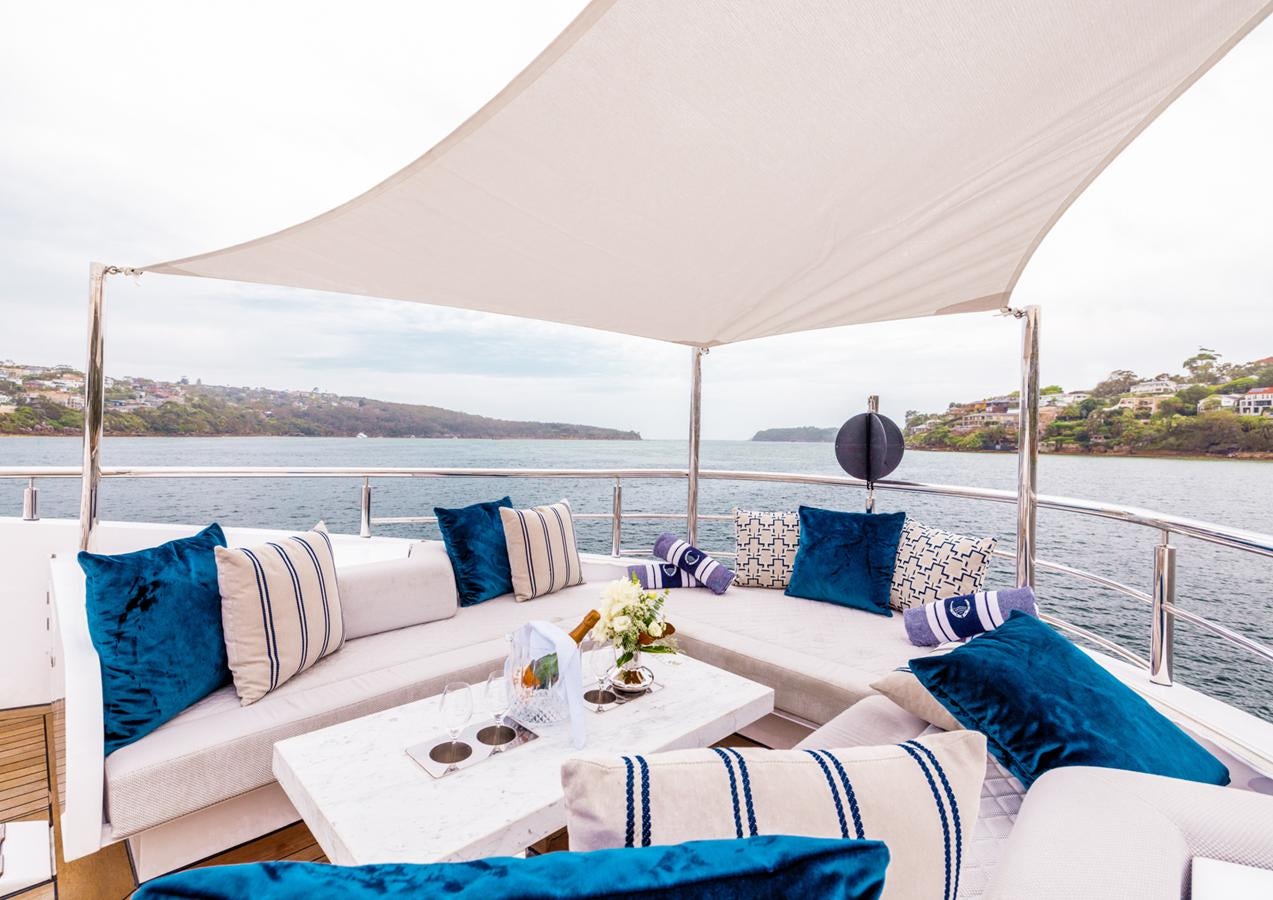 a couch and a table on a boat aboard EVOLUTION 1 Yacht for Sale