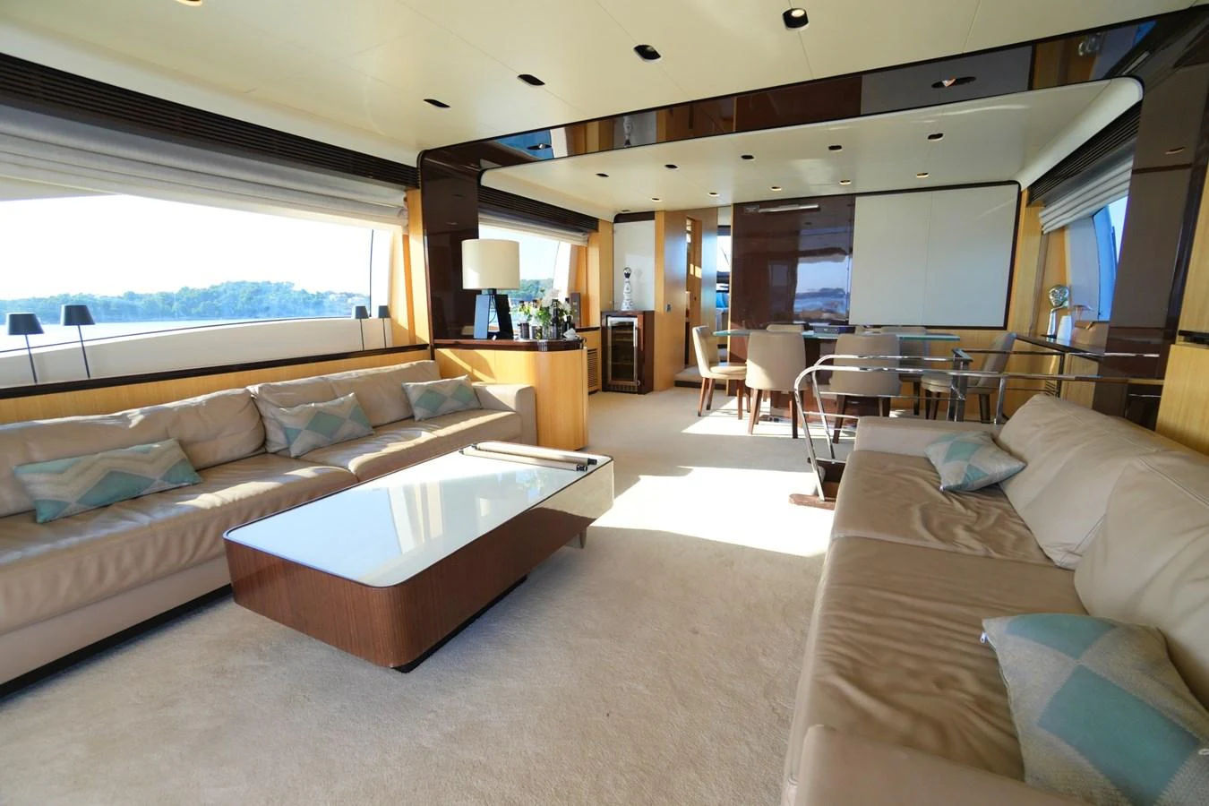 The spacious salon features plush seating, a modern coffee table, and large windows offering panoramic views. aboard HUBO Yacht for Sale