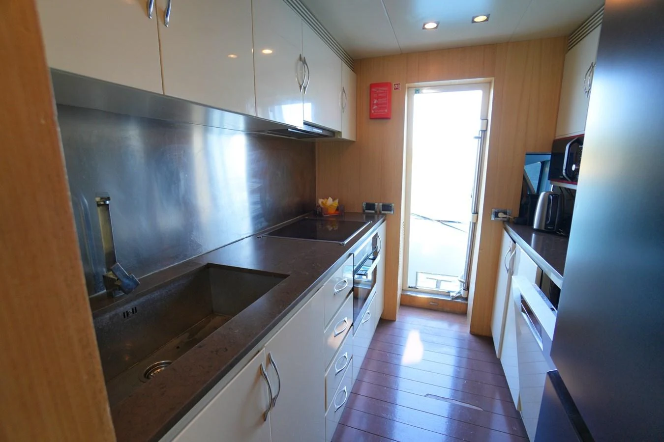The yacht's galley is equipped with modern appliances and ample counter space, perfect for preparing gourmet meals. aboard HUBO Yacht for Sale
