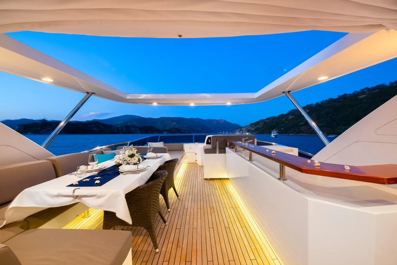 The aft deck offers a luxurious dining area with stunning views of the surrounding waters. aboard HUBO Yacht for Sale
