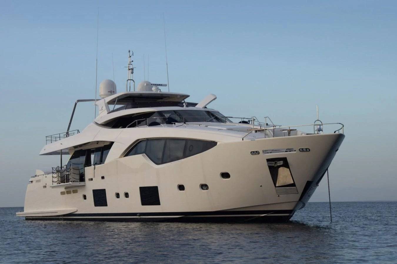 A sleek and modern yacht is anchored on calm waters, showcasing its elegant design and spacious decks. aboard HAPPY 2 Yacht for Sale