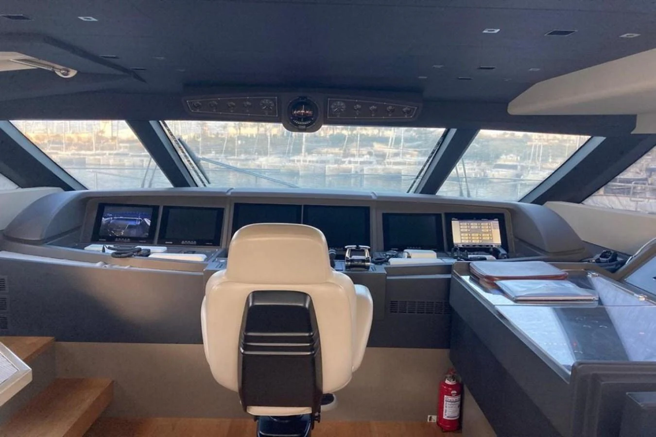 The helm station features advanced navigation equipment and a comfortable captain's chair, offering a commanding view of the surroundings. aboard HAPPY 2 Yacht for Sale
