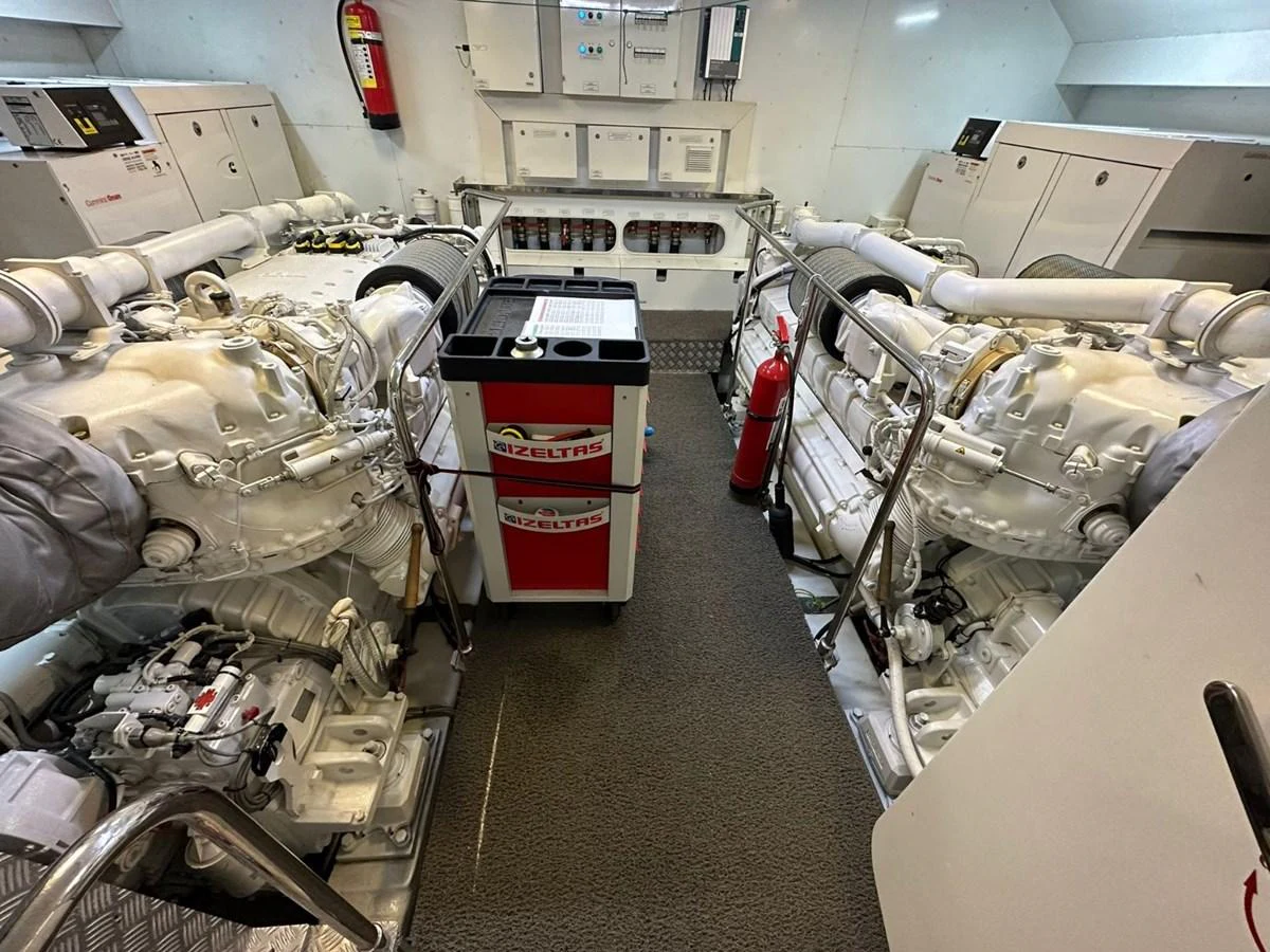The image showcases the well-maintained engine room of the yacht, highlighting its powerful machinery and organized layout. aboard HAPPY 2 Yacht for Sale