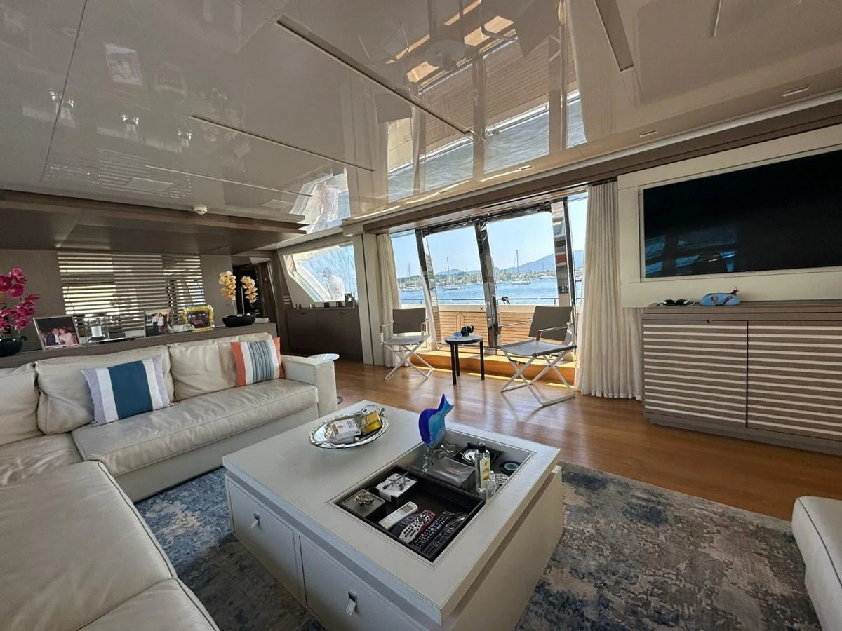 The yacht's salon offers a spacious and elegant living area with comfortable seating and a large window providing stunning views. aboard HAPPY 2 Yacht for Sale