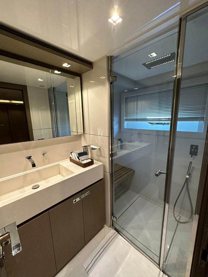 The yacht's bathroom features modern fixtures and a sleek glass-enclosed shower. aboard HAPPY 2 Yacht for Sale