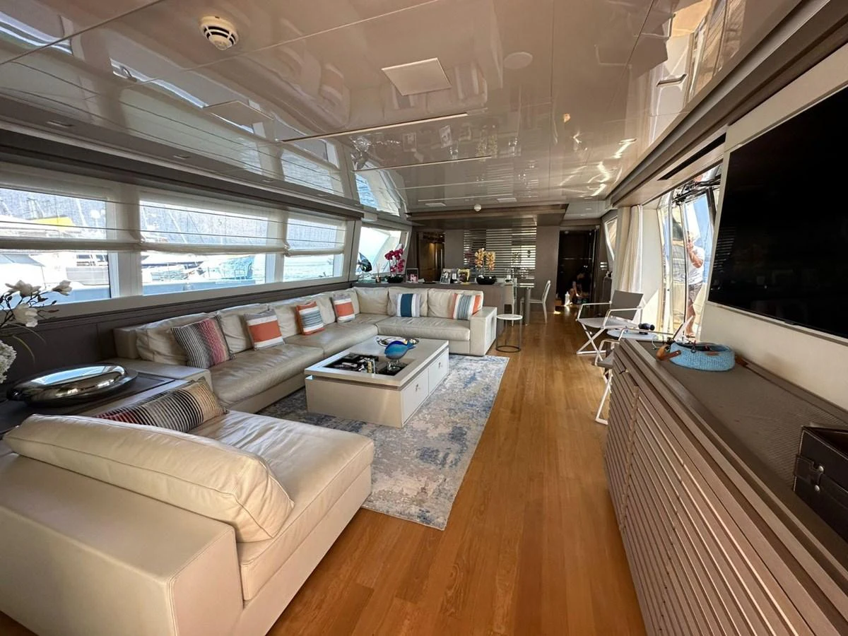 The spacious salon features a luxurious seating area with ample natural light and elegant decor. aboard HAPPY 2 Yacht for Sale