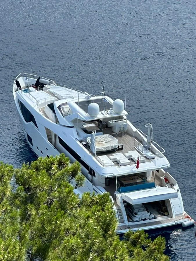 A luxurious yacht is anchored in serene waters, showcasing its spacious decks and sleek design. aboard HAPPY 2 Yacht for Sale