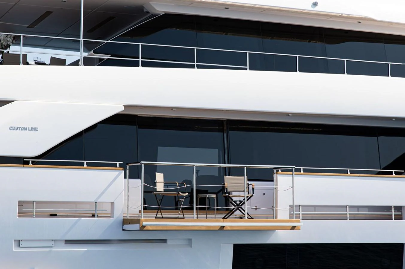 a room with a blue wall and chairs aboard HAIAMI I Yacht for Sale