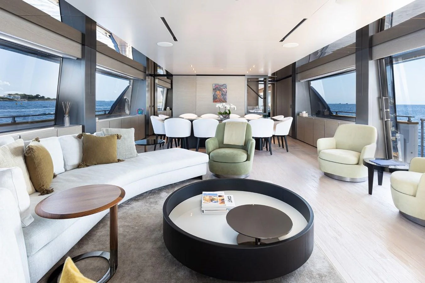 a living room with a large sofa and a round table aboard HAIAMI I Yacht for Sale