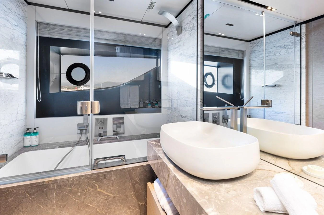 a bathroom with a large mirror aboard HAIAMI I Yacht for Sale