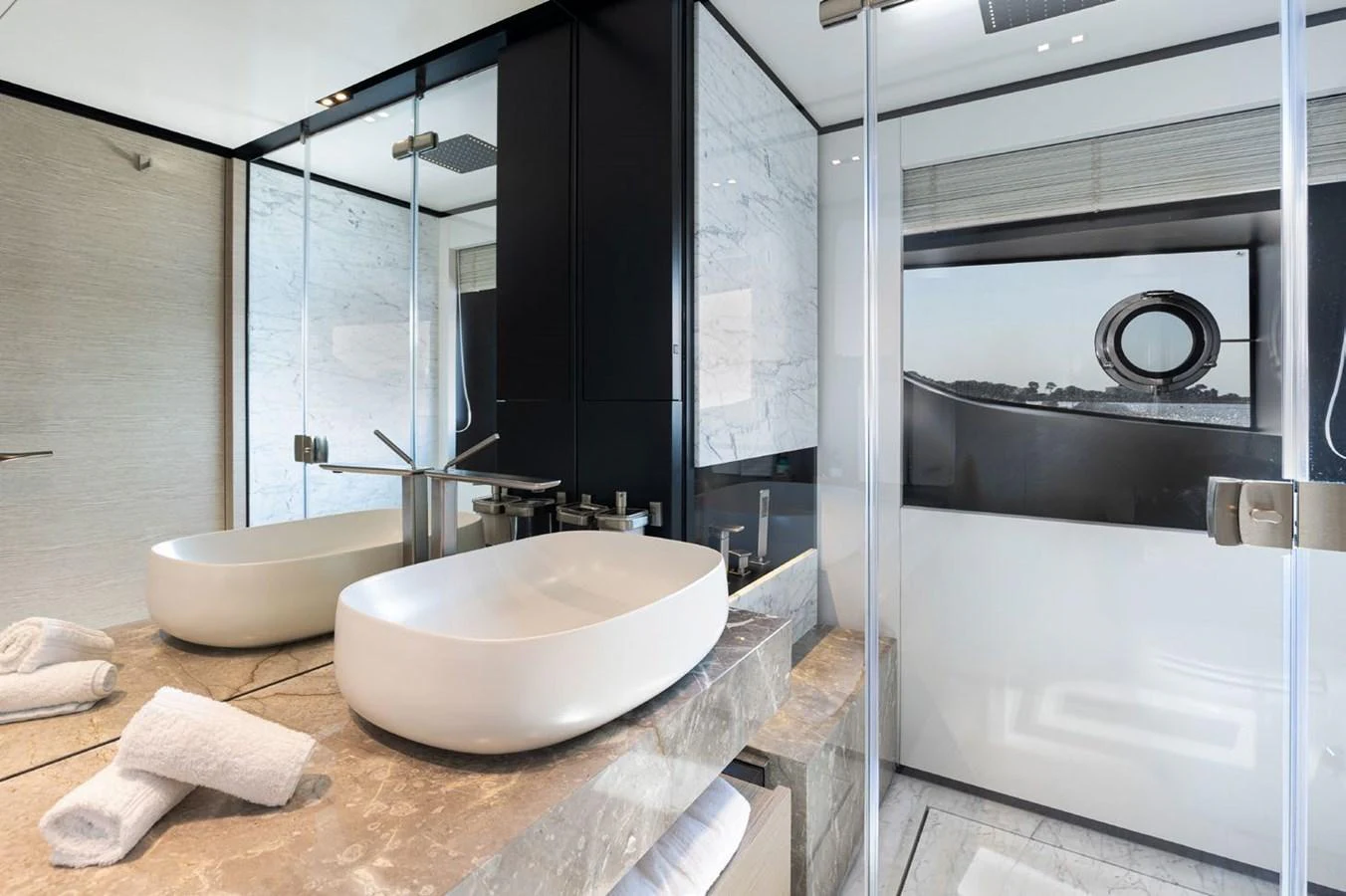 a bathroom with a sink and a large mirror aboard HAIAMI I Yacht for Sale