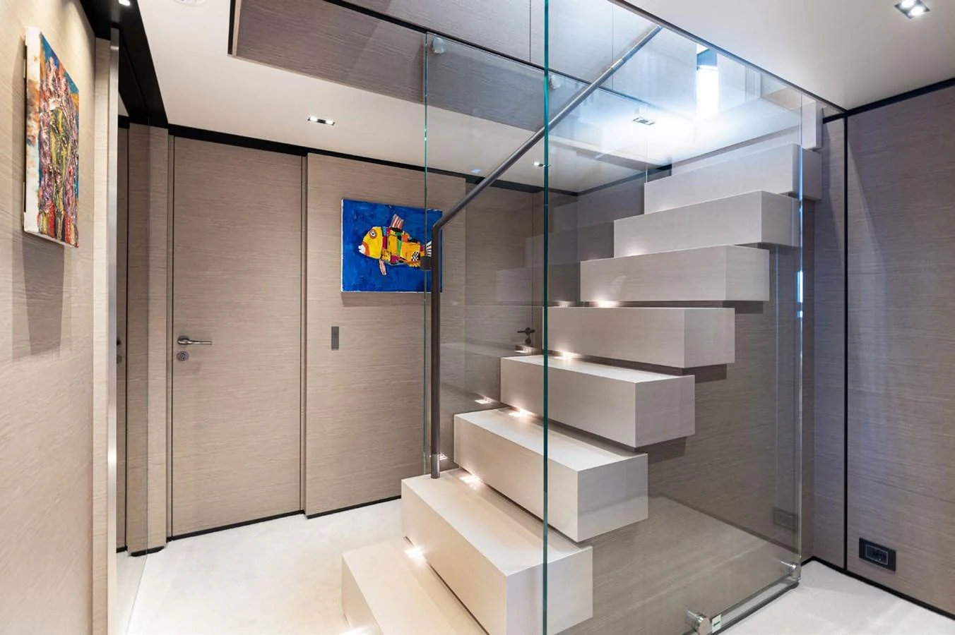 a room with a staircase and a glass wall aboard HAIAMI I Yacht for Sale
