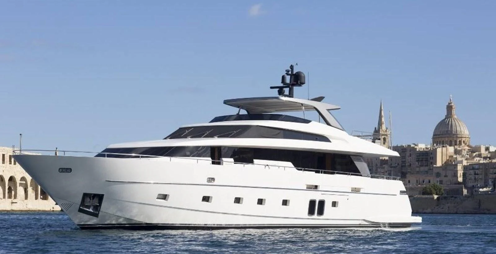 A sleek, modern yacht cruises gracefully against a picturesque coastal backdrop. aboard SANLORENZO Yacht for Sale