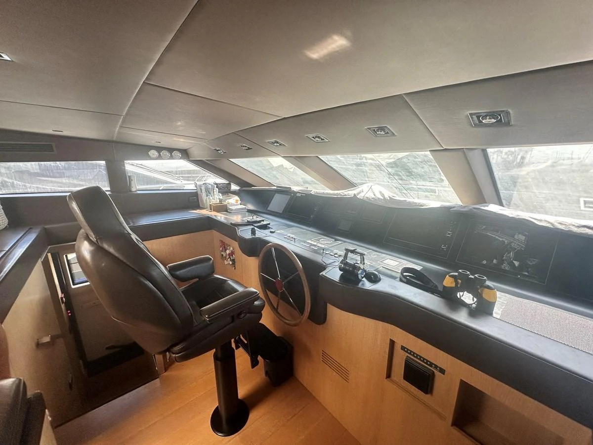 The helm station features a sleek design with advanced navigation equipment and a comfortable captain's chair. aboard SANLORENZO Yacht for Sale