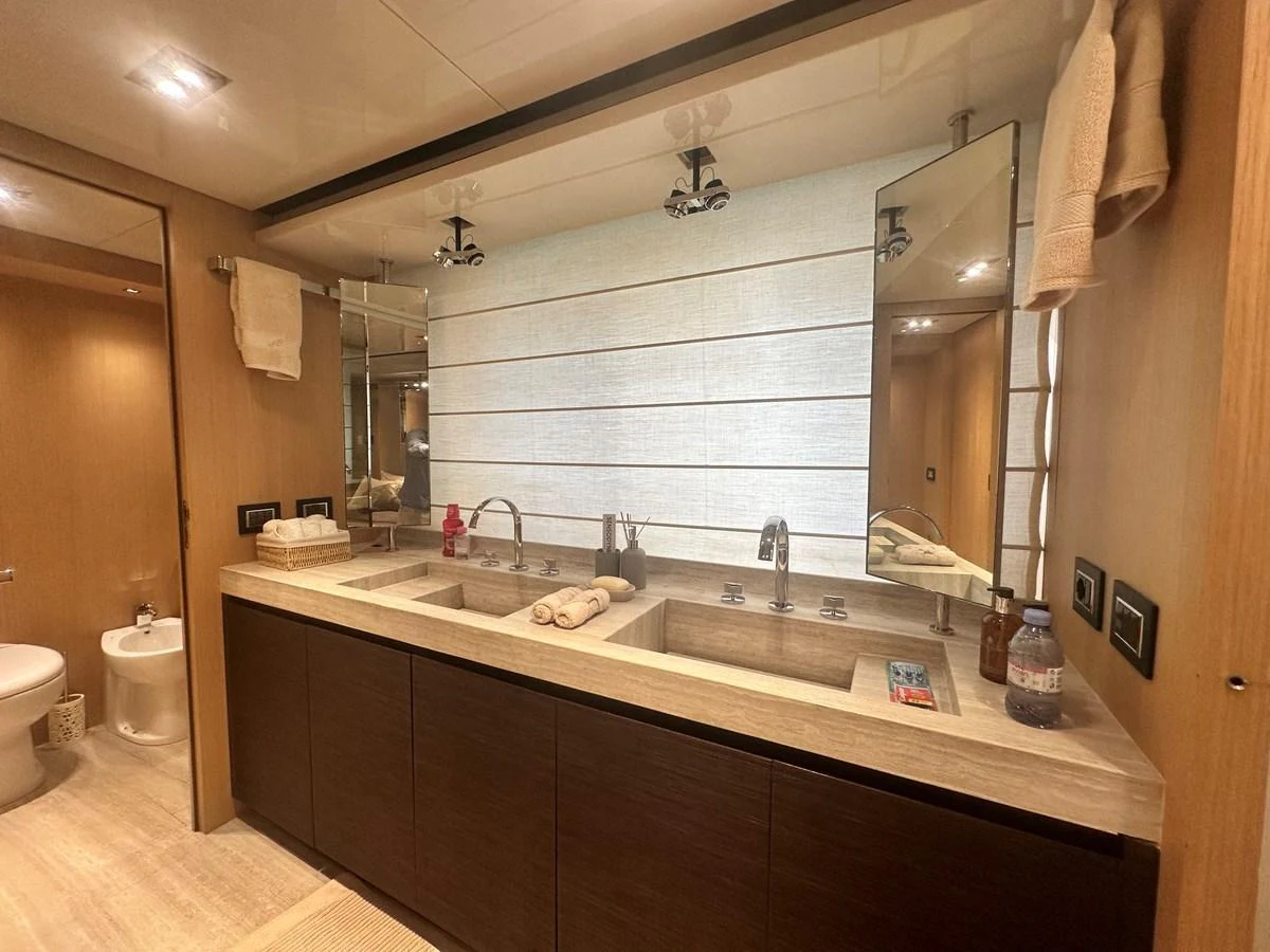 The yacht's bathroom features a double sink vanity with modern fixtures and ample lighting. aboard SANLORENZO Yacht for Sale