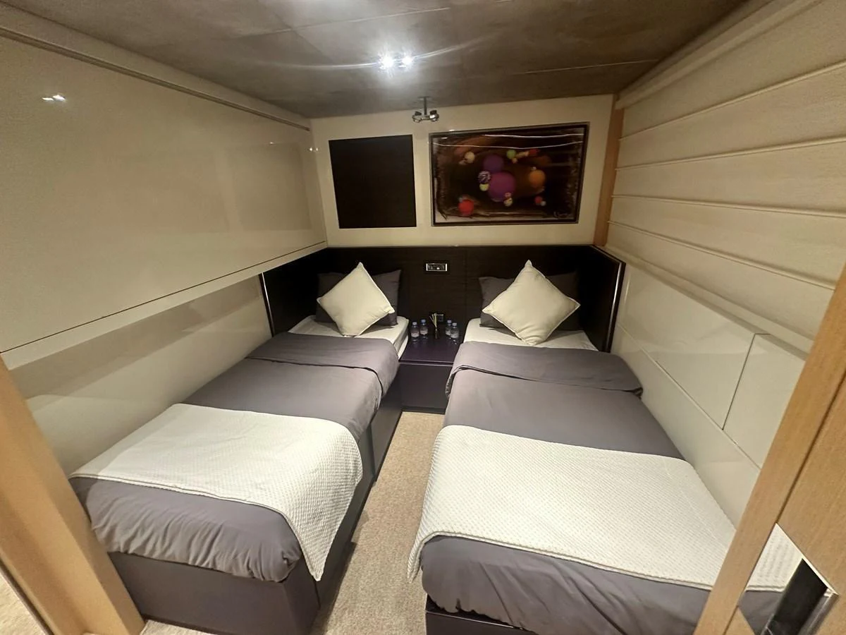 The twin stateroom offers a cozy and elegant sleeping area with two single beds and modern decor. aboard SANLORENZO Yacht for Sale
