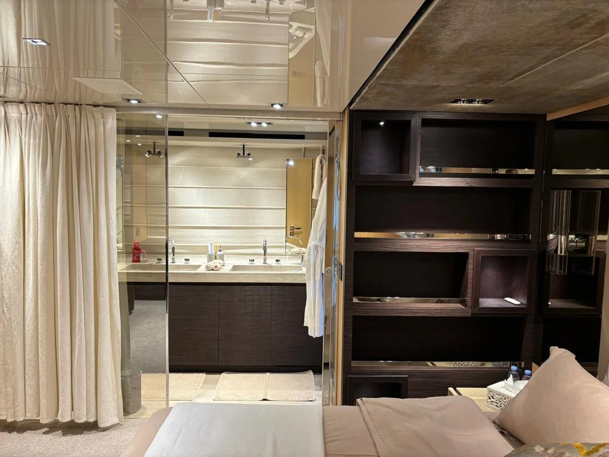 The master stateroom features a luxurious bed, ample storage, and an en-suite bathroom with double sinks. aboard SANLORENZO Yacht for Sale