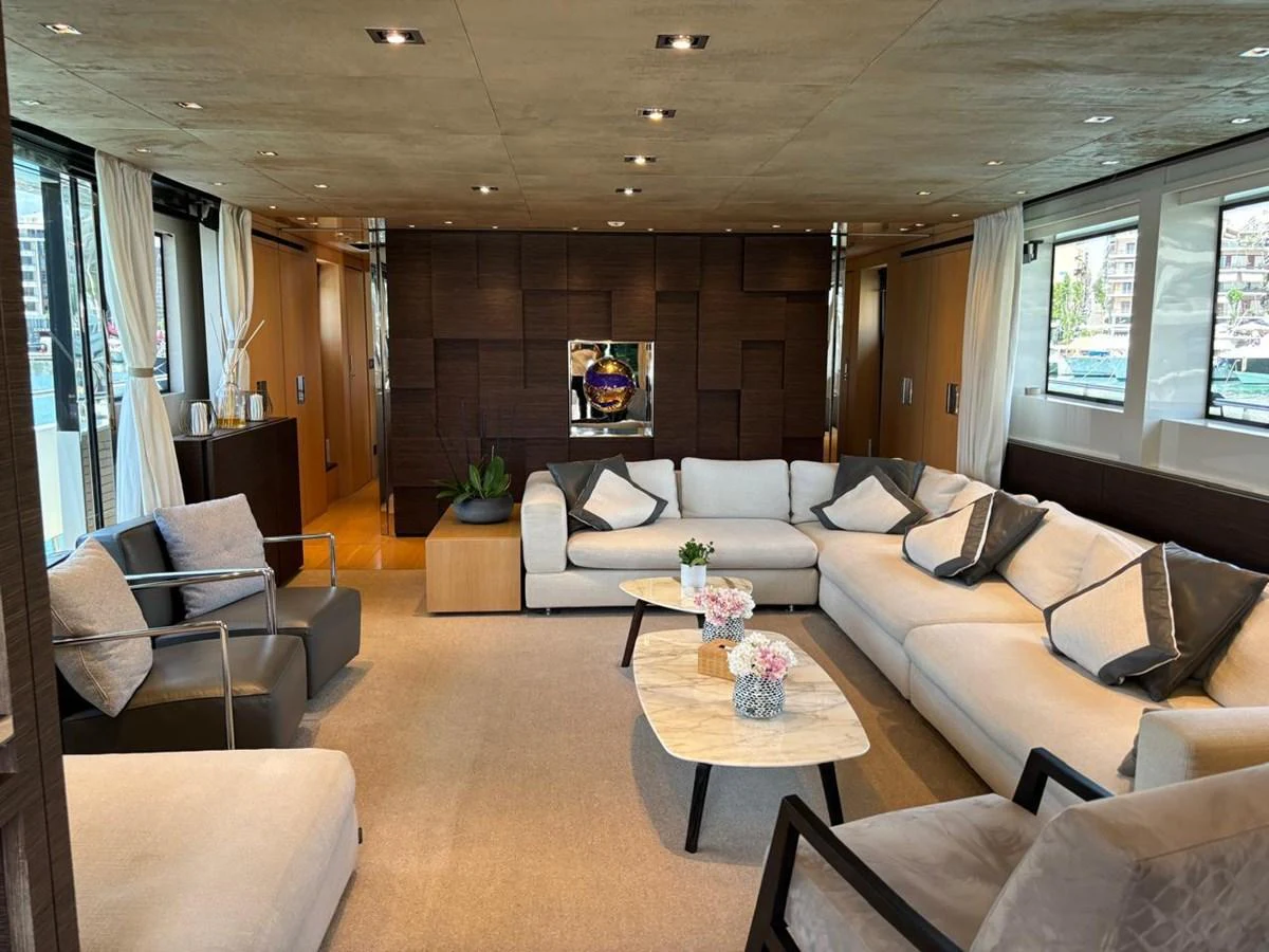 The salon features a spacious and elegantly designed seating area with modern furnishings and large windows. aboard SANLORENZO Yacht for Sale