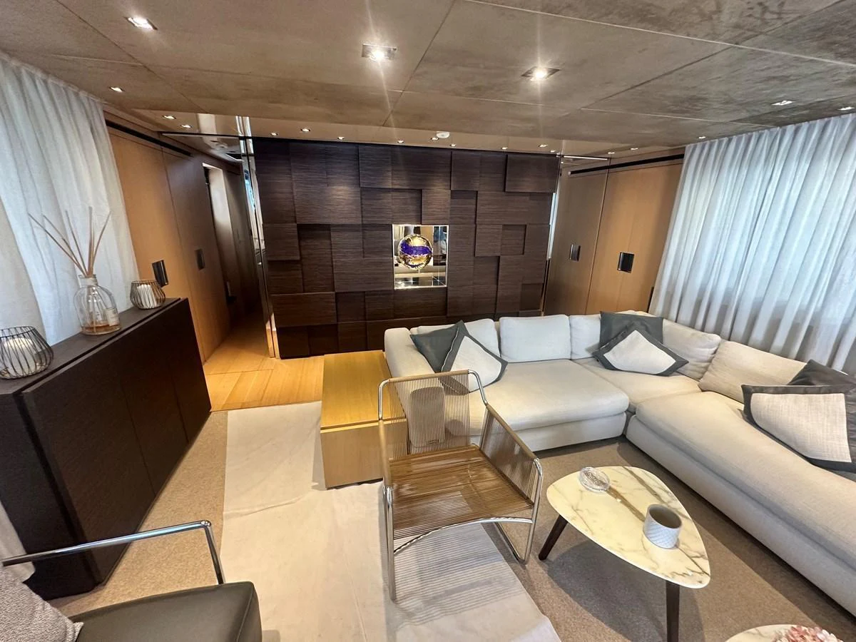 The salon features a modern and cozy seating area with elegant decor and ample natural light. aboard SANLORENZO Yacht for Sale