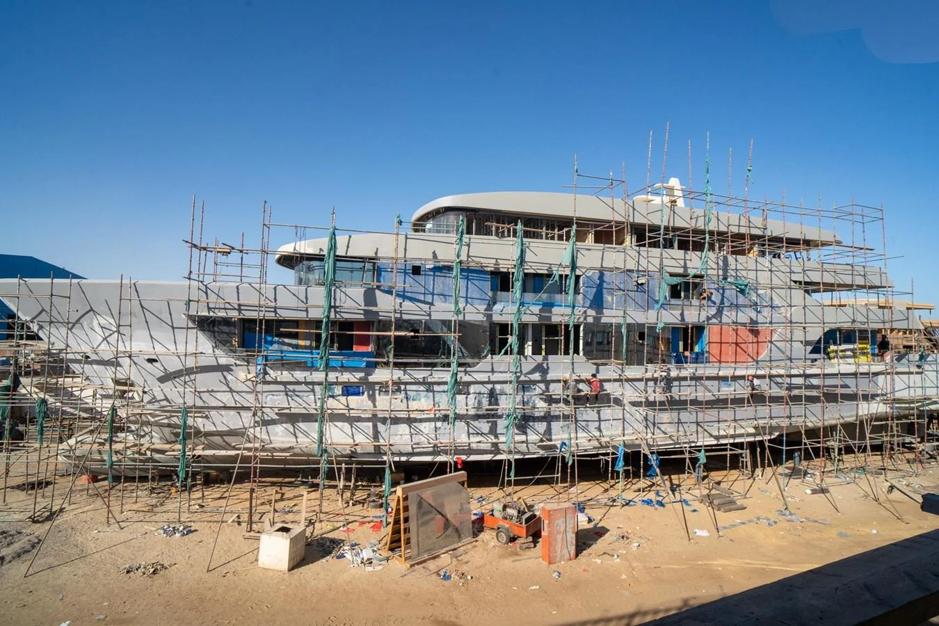 The yacht is under construction, surrounded by scaffolding and equipment. aboard JASMINE Yacht for Sale