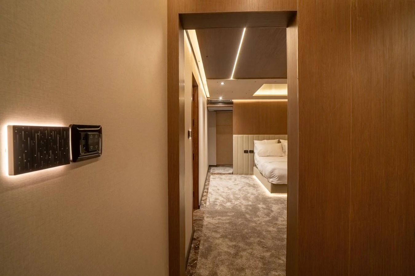 A luxurious stateroom with warm lighting and plush carpeting. aboard JASMINE Yacht for Sale