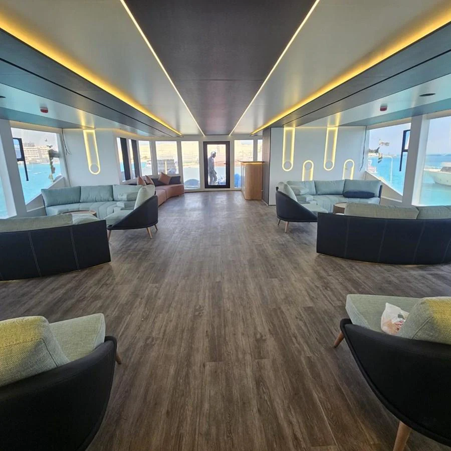 The spacious salon features modern furnishings and panoramic windows offering stunning sea views. aboard JASMINE Yacht for Sale